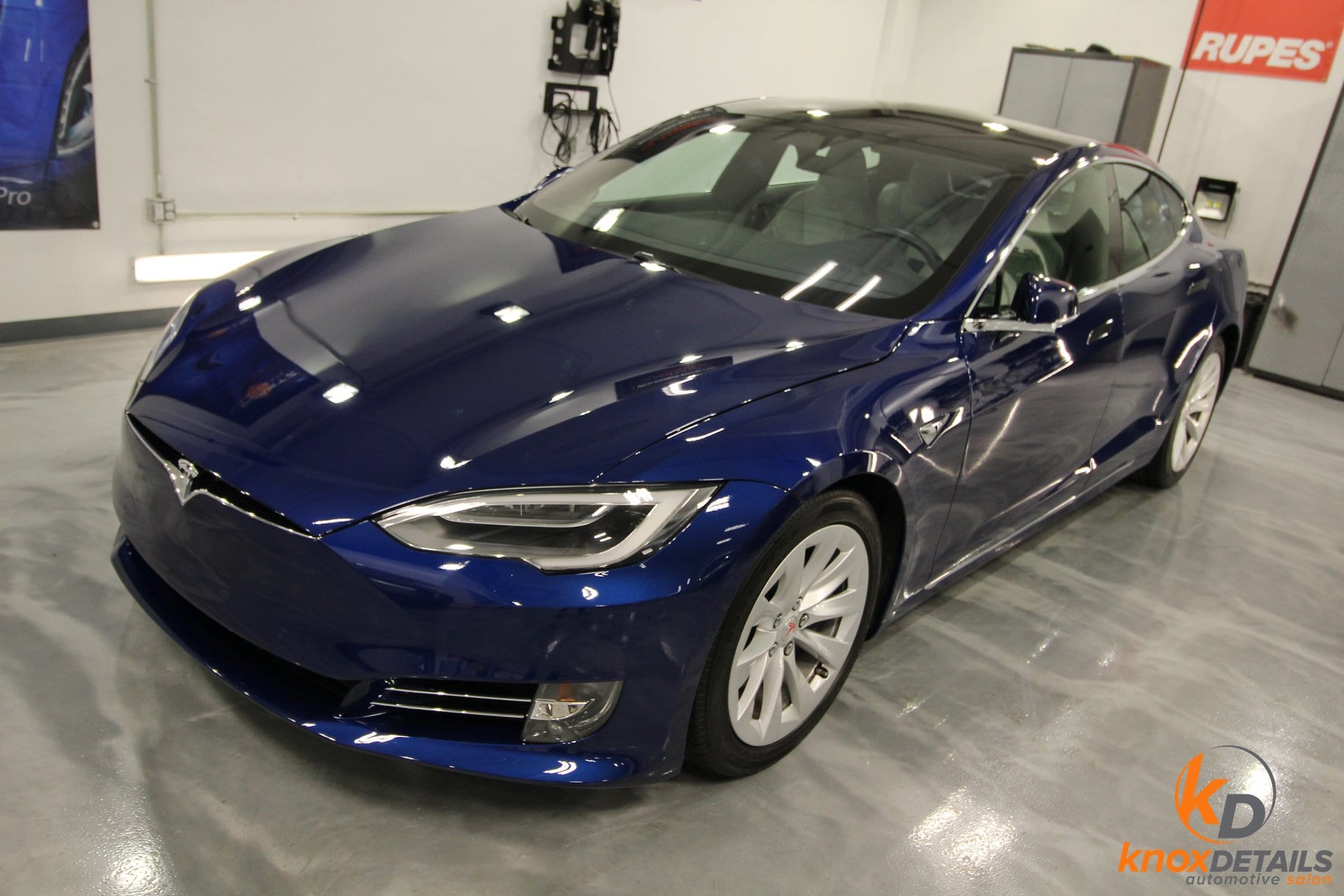 a blue tesla with paint protection film and ceramic coating